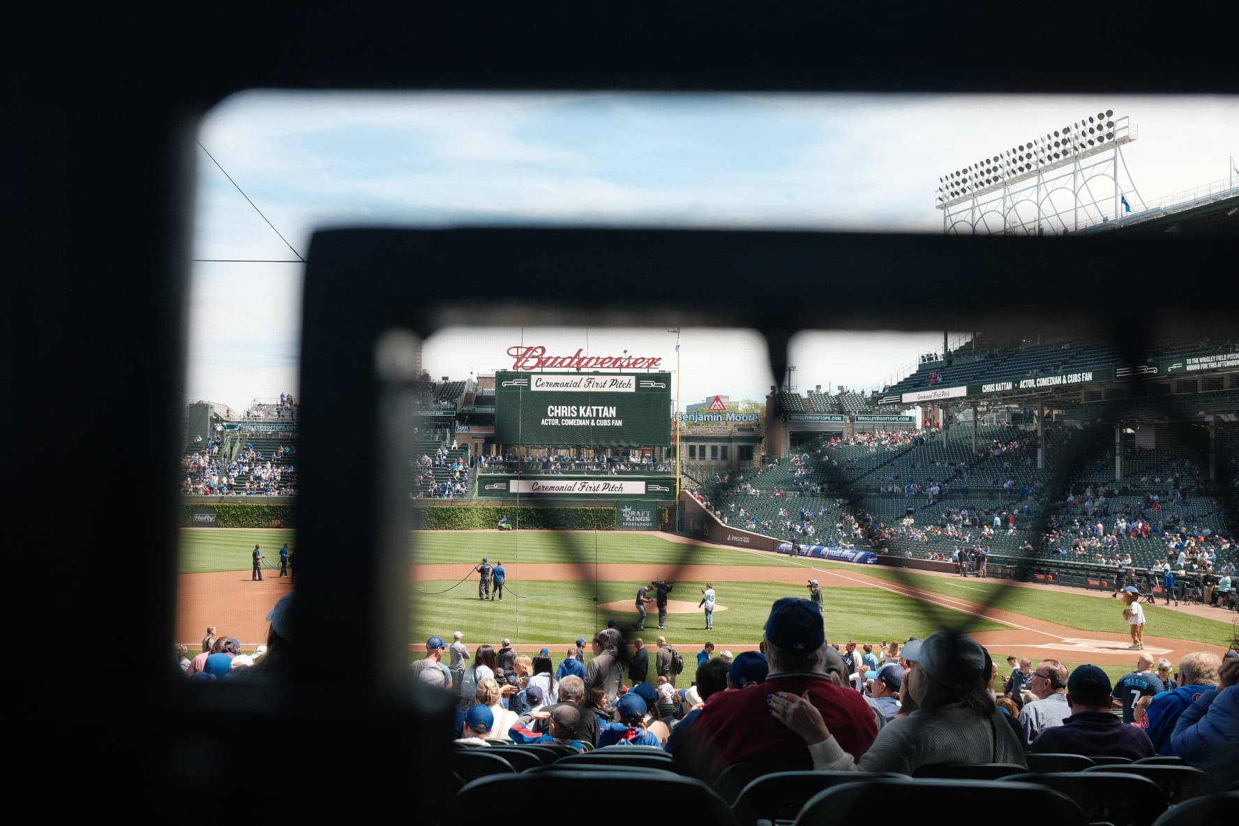 Wrigley Field framed through a gap in the stands during a ceremonial first pitch