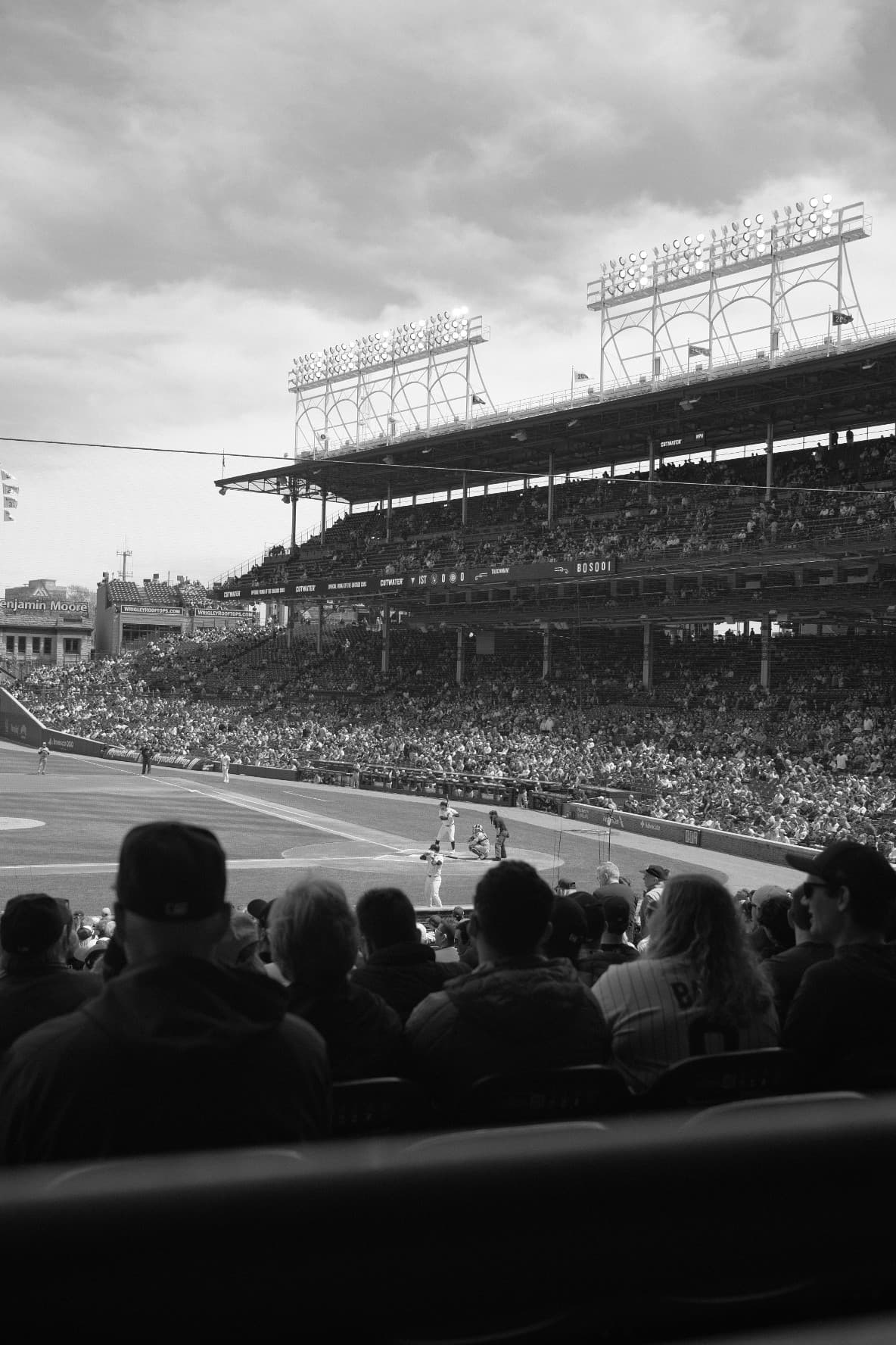 Black and white view of a game at Wrigley Field under the light towers
