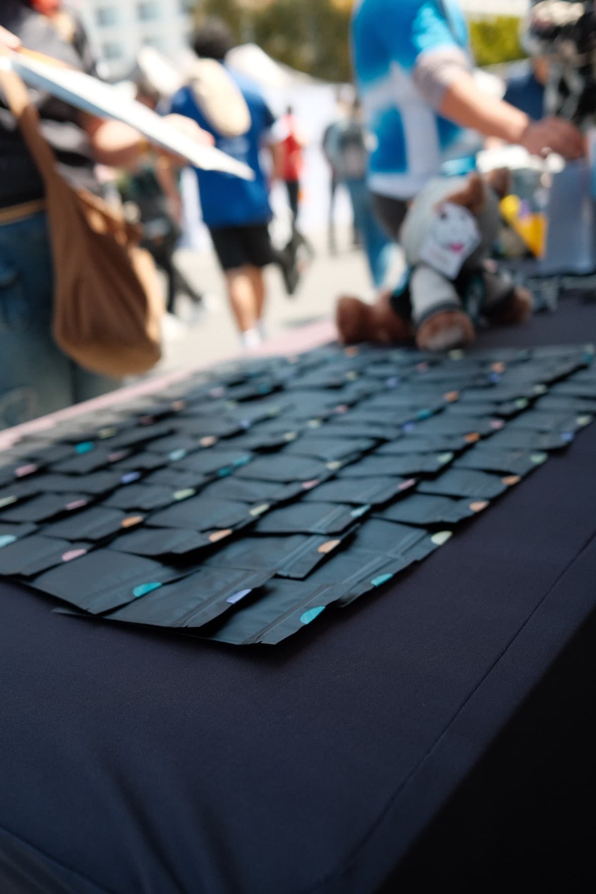 Rows of black merch packets laid out on a table at an Immortals fan event