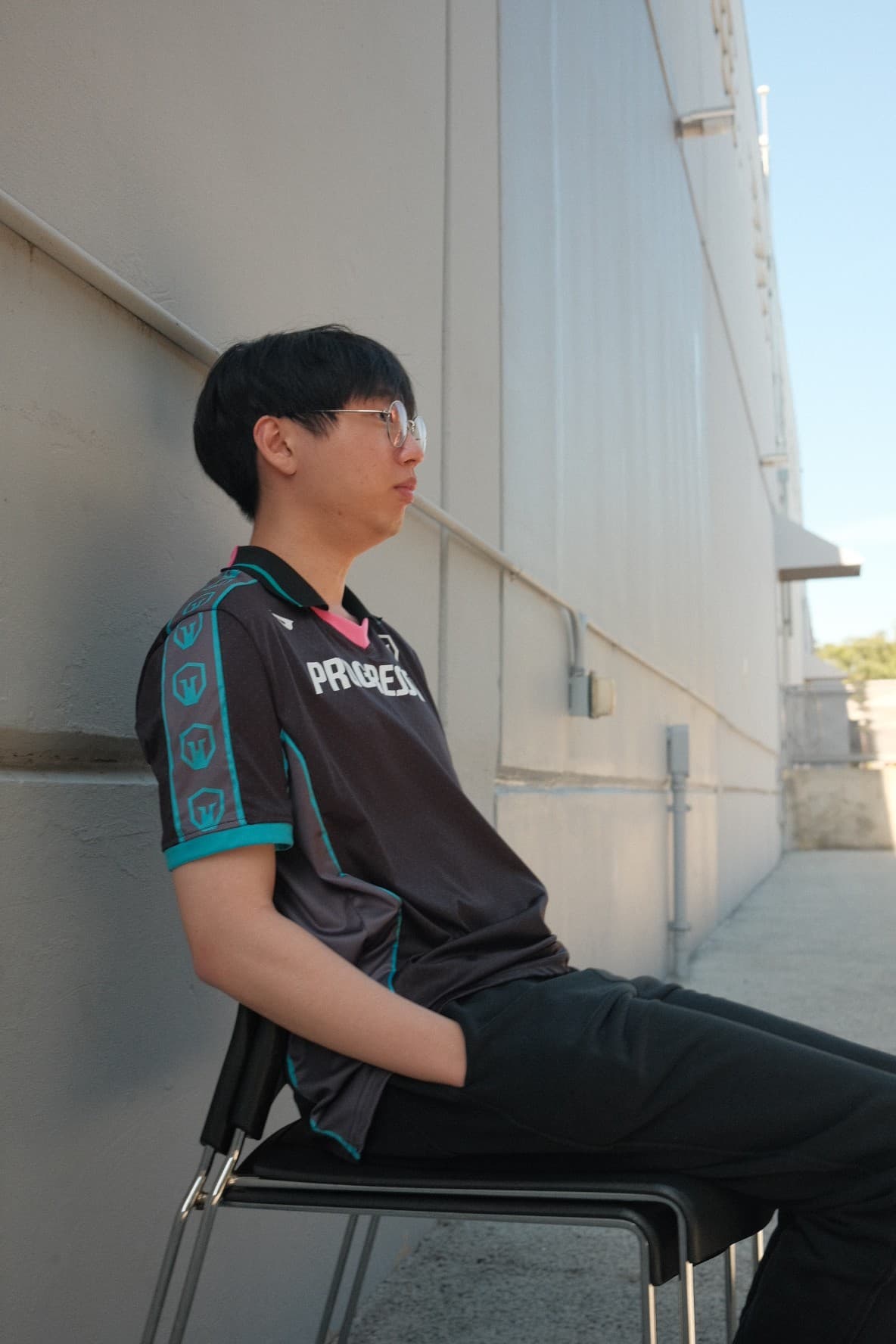 An Immortals player in a Progressive jersey sitting against a white wall